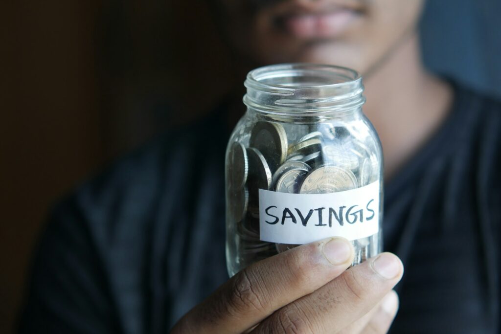 coins on a mason jar indicating savings